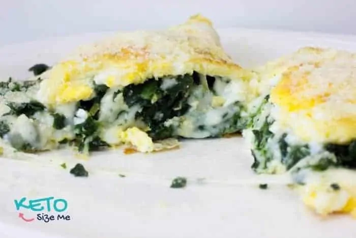 keto omelette with spinach and mozzarella cheese cut in half on plate