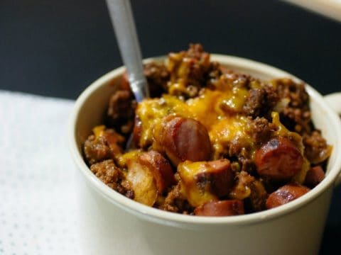 Keto Chili Cheese Hot Dog Casserole in a large soup mug with a spoon