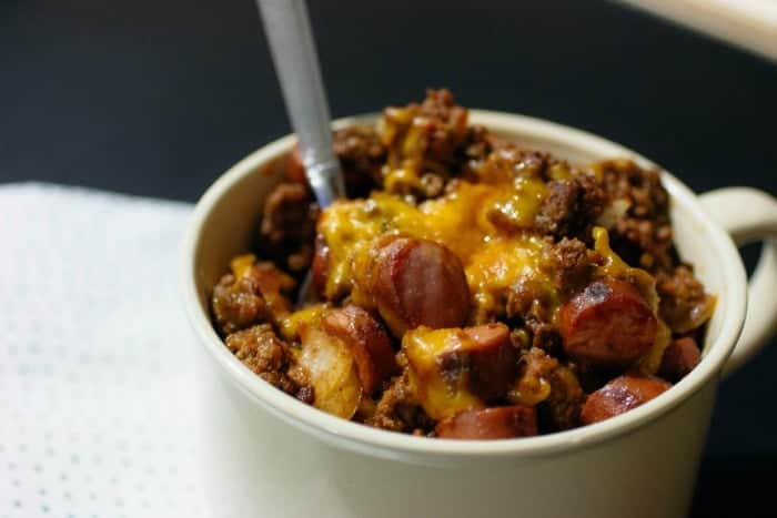 Keto Chili Cheese Hot Dog Casserole in a large soup mug with a spoon