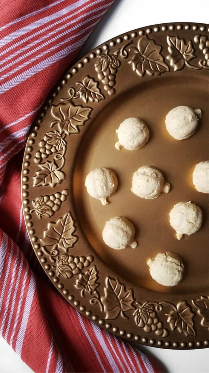 pumpkin shaped fat bombs on a gold serving tray 