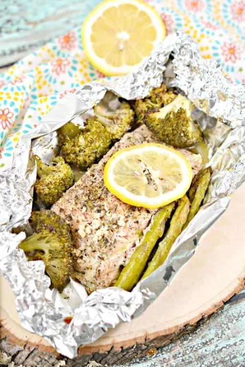 Keto Garlic Herb Salmon Foil Packets served on a wooden plate 