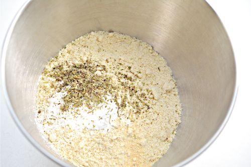 Italian seasoning, Garlic powder, Baking powder, Baking soda, Almond flour, and  Everything Bagel seasoning in a mixing bowl 