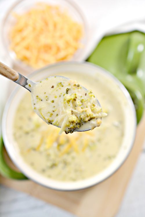 spoonful of broccoli cheddar soup over bowl 